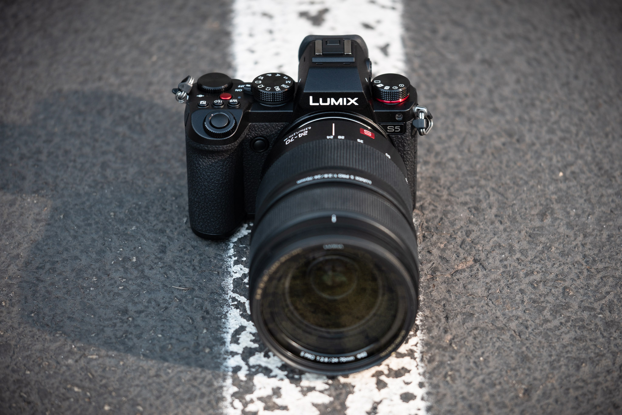 Product photo of Panasonic Lumix S5 camera with Panasonic 24-70mm f/2.8 lens attached.